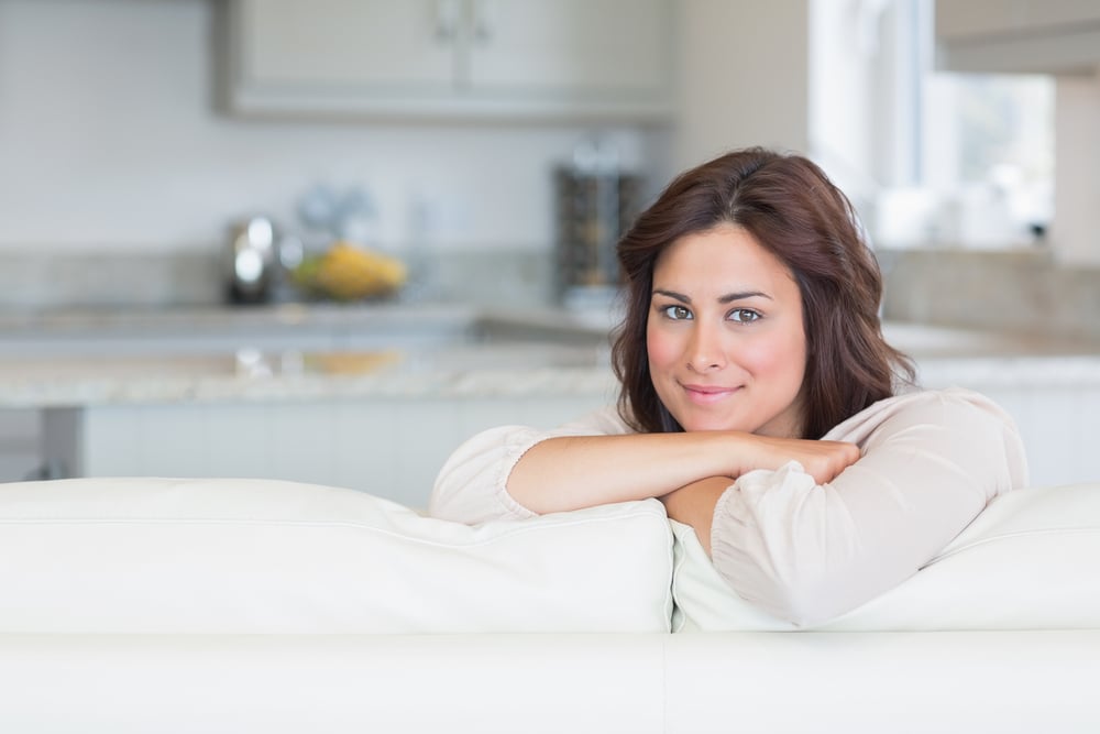 Brunette relaxing on the sofa and smiling